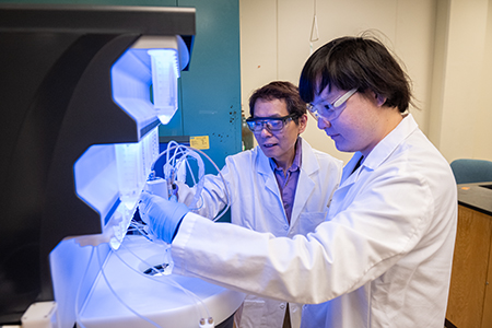 Two researchers in a biomanufacturing lab at K-State