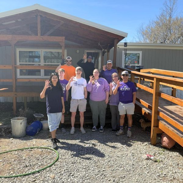 Students pose with a porch ramp they built