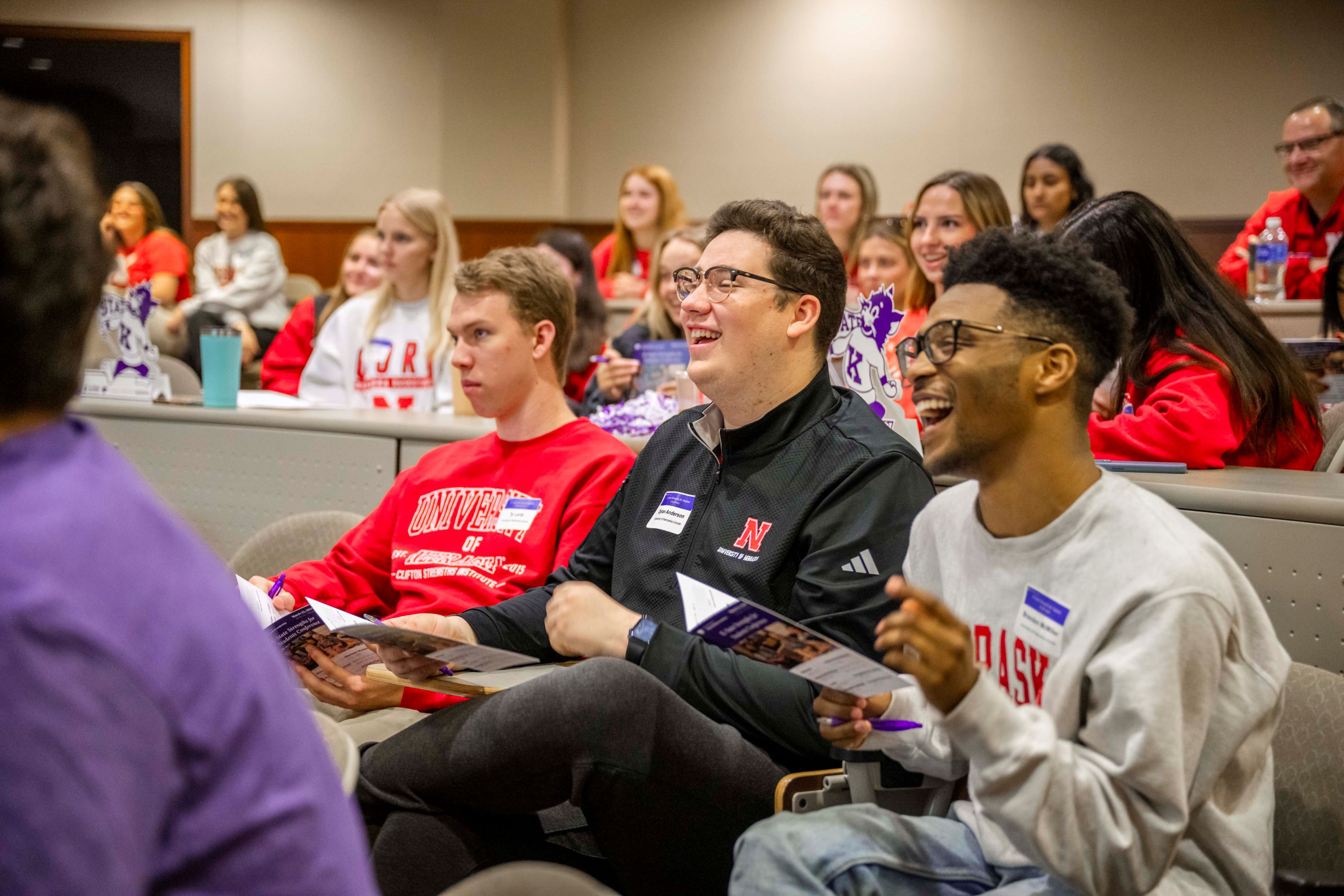 Students sitting in lecture room smiling