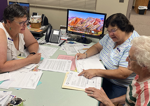 Susie Latta, left, K-State Research and Extension — Marshall County family and consumer sciences agent, and Arlene Wessel, center, community health worker, meet with a community member in Marshall County.