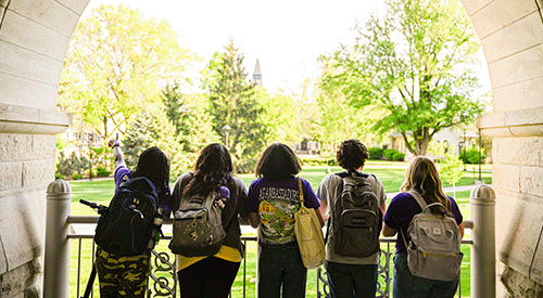 Students stand on a ramp at Hale Library, overlooking campus