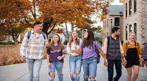 Students walk on campus during a fall day