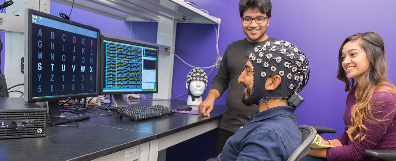 Three graduate students perform an experiment in the BBS Lab.