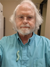 Michael Kanost, Ph.D. with a tobacco hornworm on his shirt.