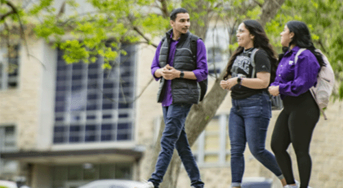 A group of students walk together on campus.