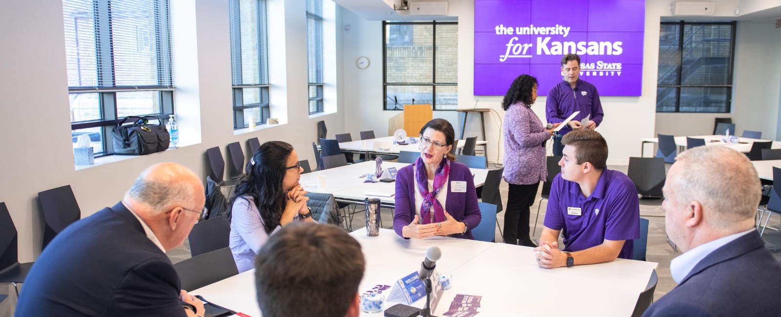 This photo shows a community discussion at a K-State community visit. 