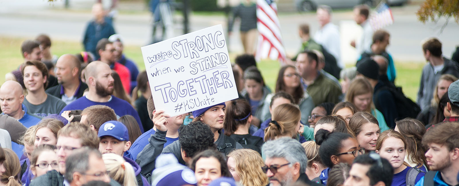 KSUnite 2017 - student holding up banner in crowd that says we are strong when we stand together