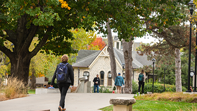 students walking across the campus quad in fall