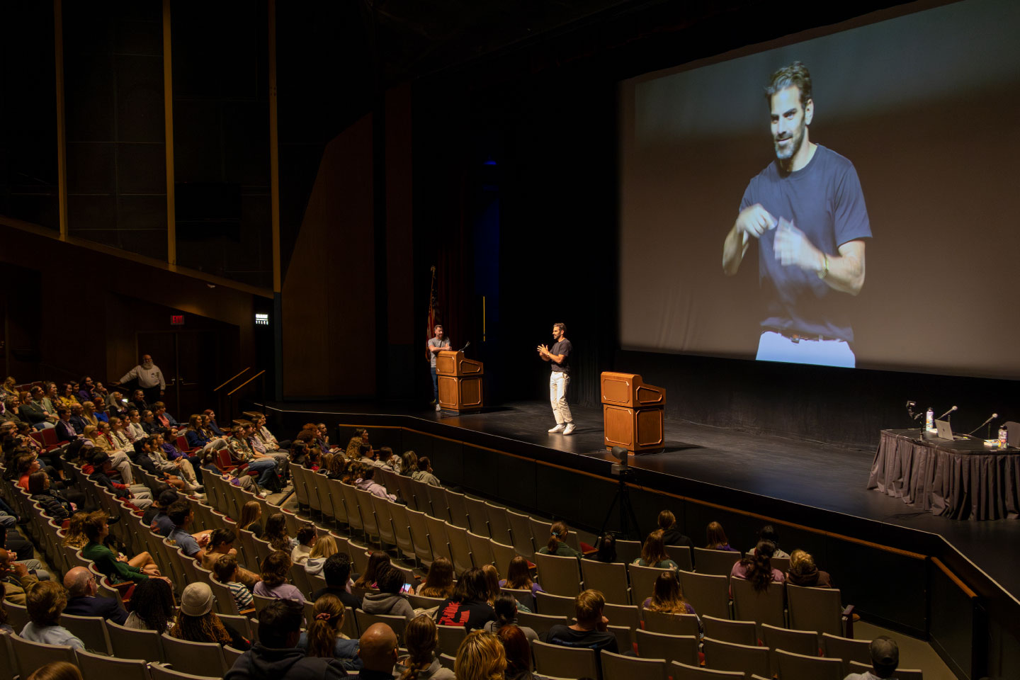 Nyle DiMarco on stage in McCain auditorium