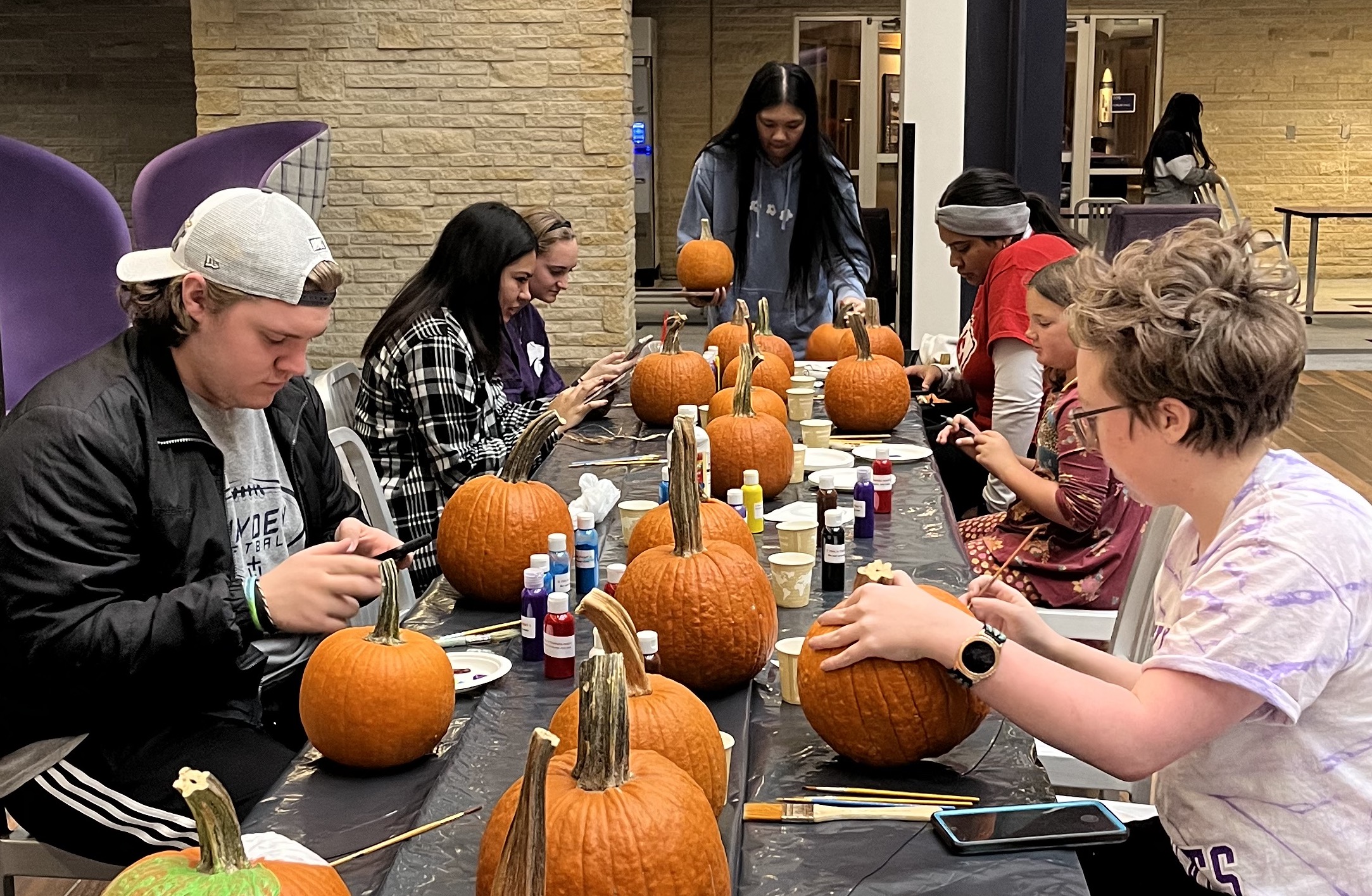 Students painting pumpkins