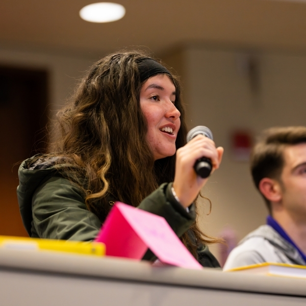student speaking into microphone