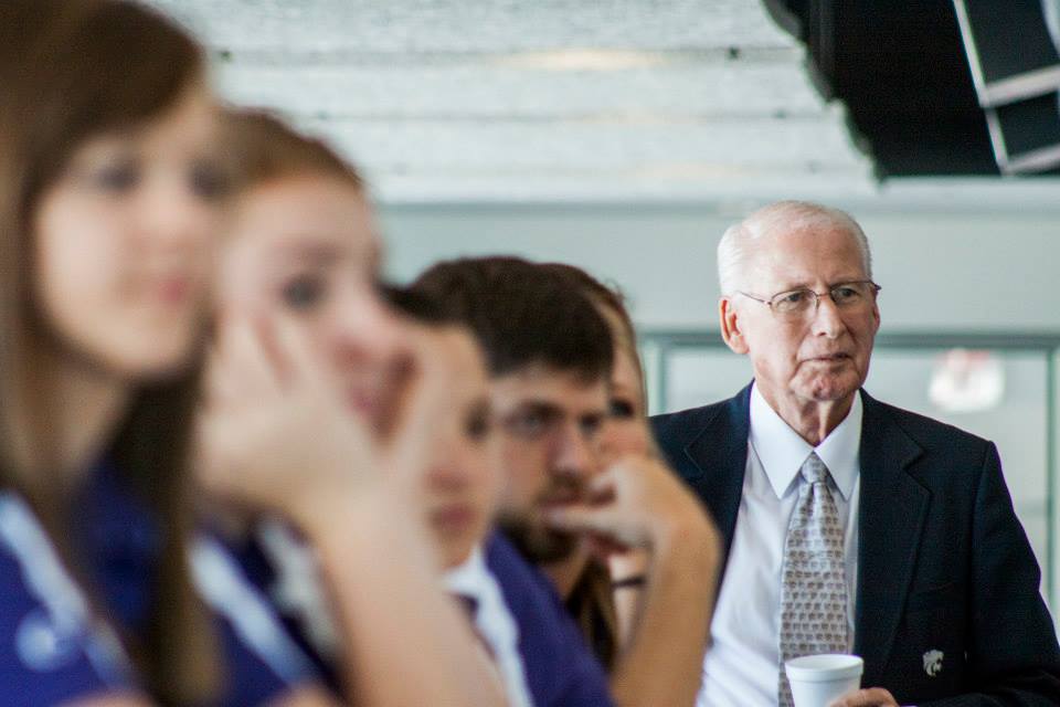 Close up of Coach Snyder holding his coffee cup at a Snyder Fellows meeting