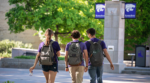 Three students cross Bosco Plaza.