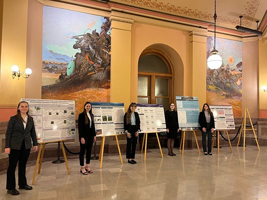 A group of students presenting posters in the Capitol.