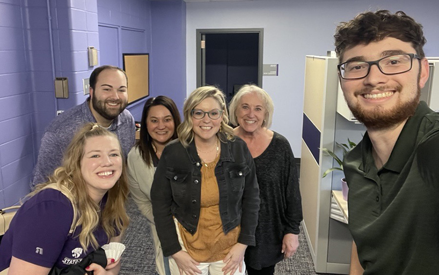 Six people in group selfie with male K-State student in the foreground on the right side.