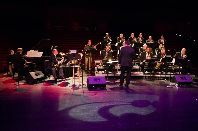 A group of musicians performs onstage.