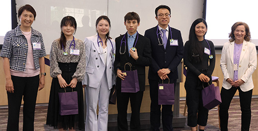 A group of students who recently graduated the U.S.-China Joint Doctor of Veterinary Medicine Program stand in a line with the dean of the college.