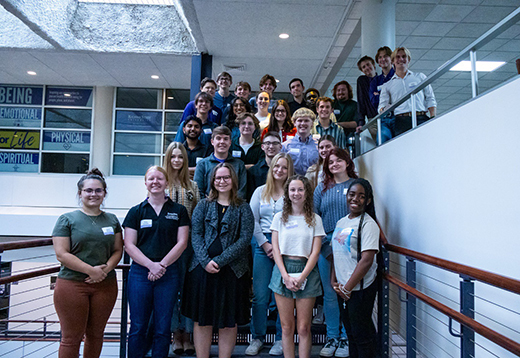 A group of student standing on a staircase