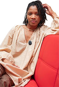 A Black woman on a red couch with a white background