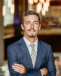 A young man in a gray striped blazer.