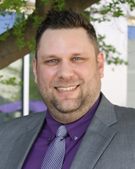 Michael Oetken smiles for a portrait.