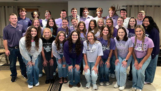 A group of students in purple shirts.