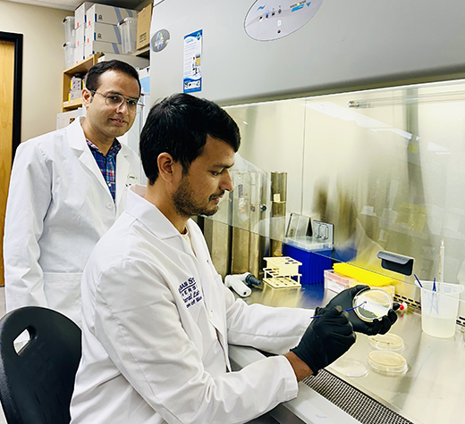 Two-scientists-in-white-lab-coats-in-the-lab