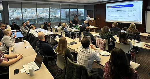 A-room-of-people-watching-a-presentation