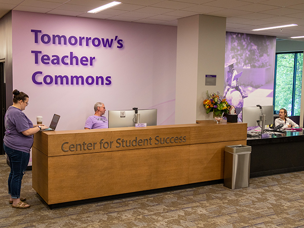 A warm, open area with a long wooden reception desk in Bluemont Hall's first floor now serves as a central space for the K-State College of Education'