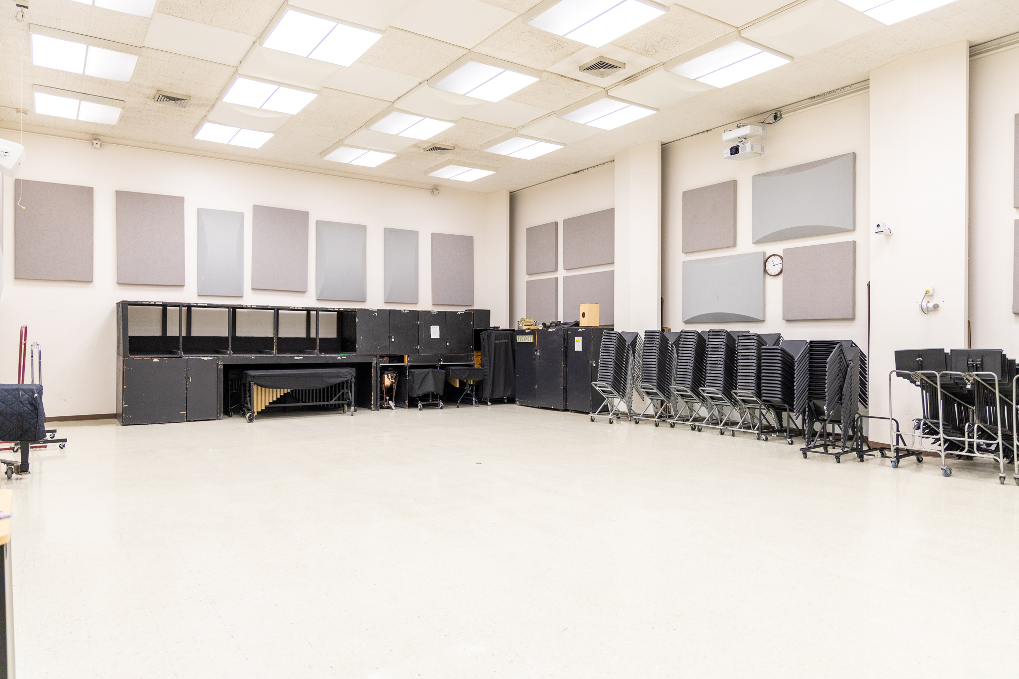 large room with chairs and cabinets along the wall