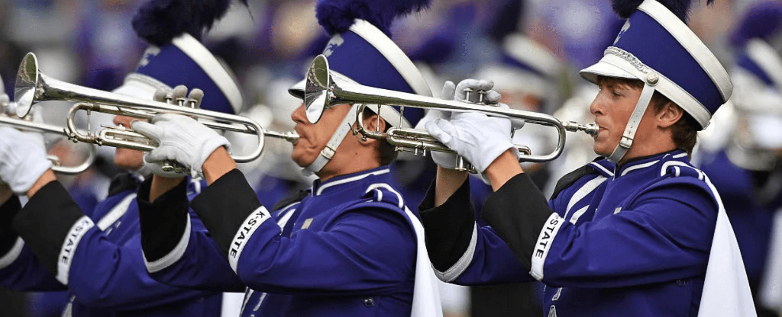 trumpet players in marching band uniforms