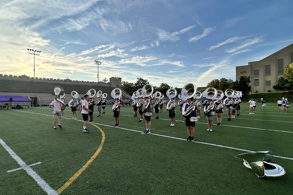 A group of tubas stand in formation during a marching band rehearsal in K-State's Memorial Stadium.