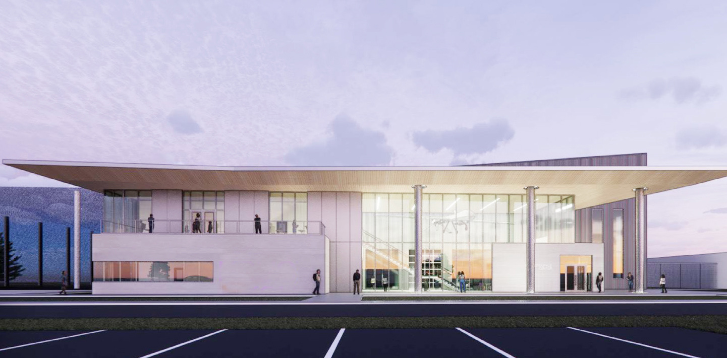 A rendering of a sleek rectangular building with light stone exterior and many windows stands tall against a light purple sky. The flat, rectangular roof gives the building an aerodynamic look. Students mill about in front of the building, and through the windows, you can see a large uncrewed aircraft suspended from the ceiling inside.