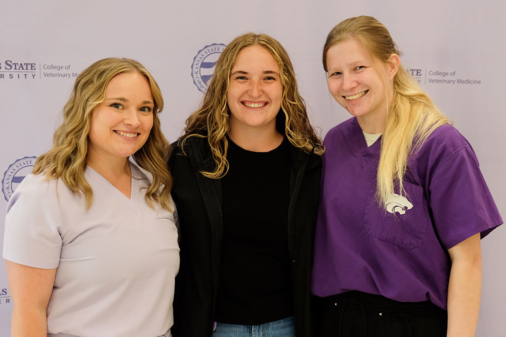 Three women pose for a photo. 
