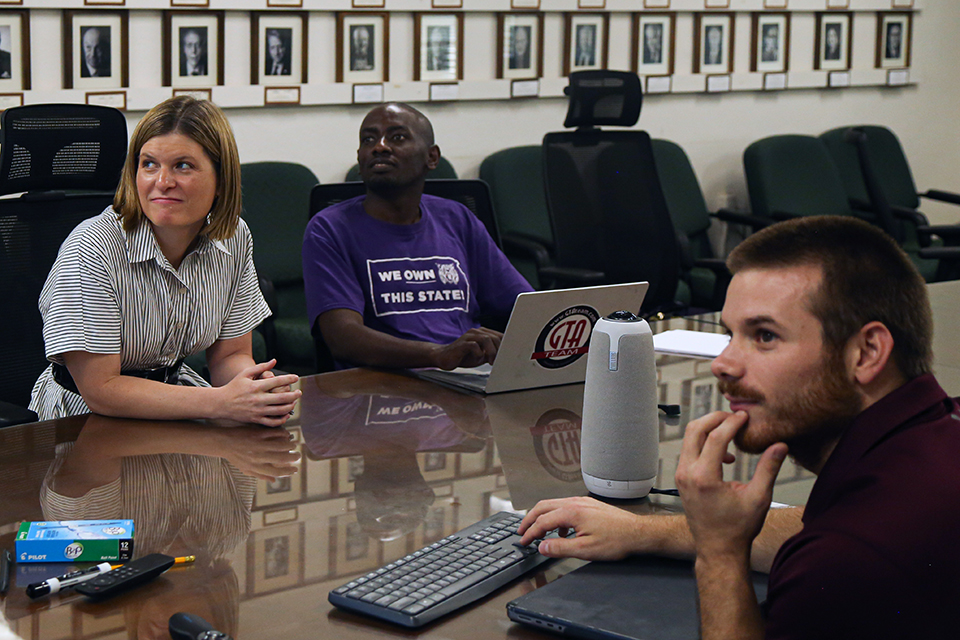 College professor Amanda Gaulke looks at a student from across a classroom table.