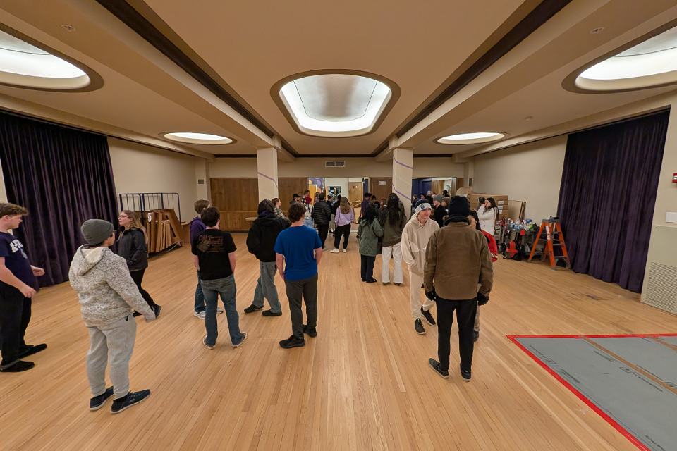About a dozen college students gather in a large, open and recently renovated residence hall lobby.