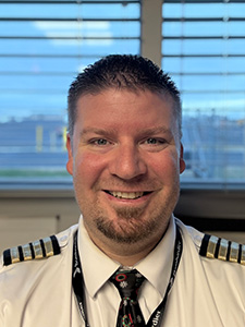 Devin larm smiles for a portrait