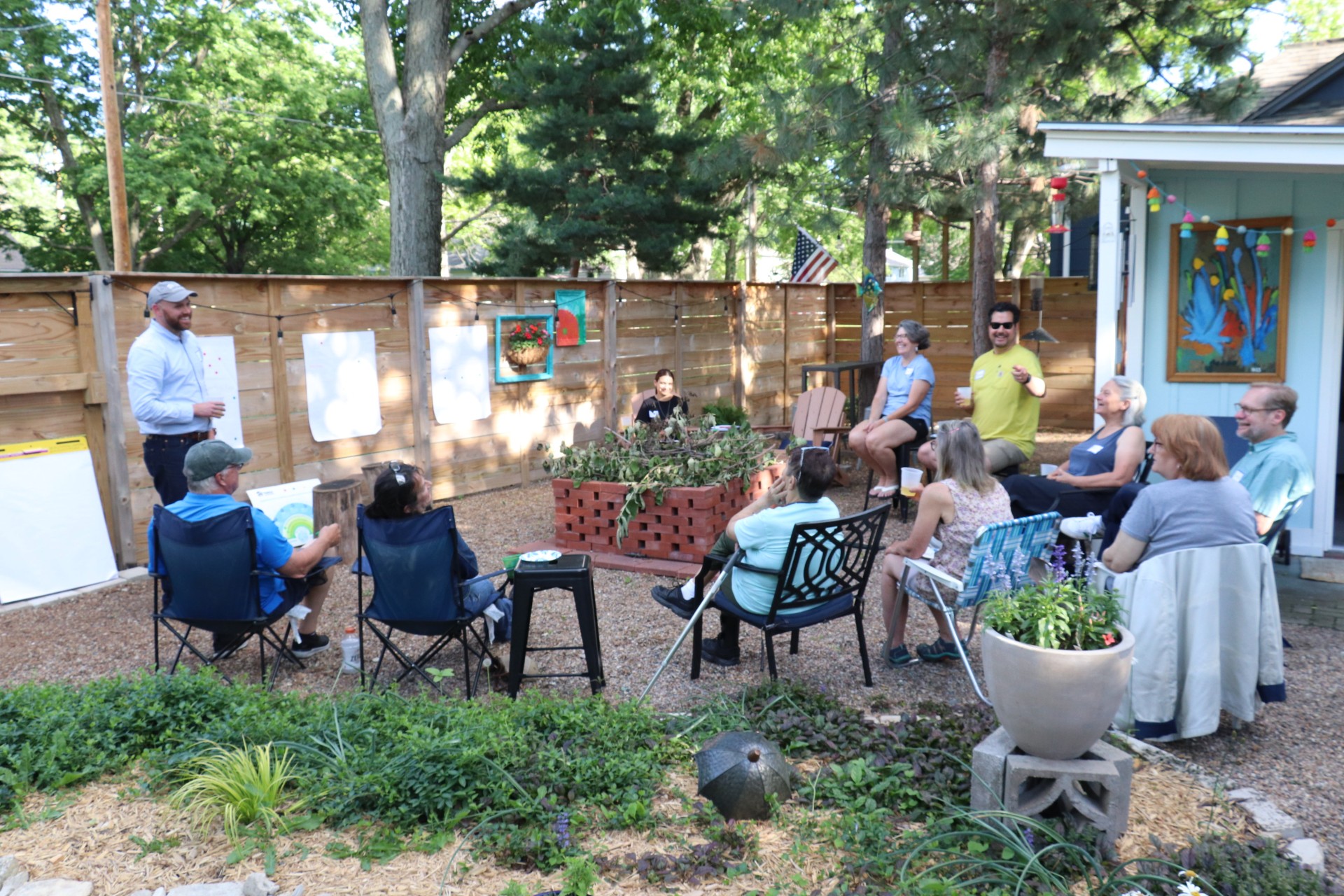 A group of people participate in a workshop with colorful scarves and musical instruments. 