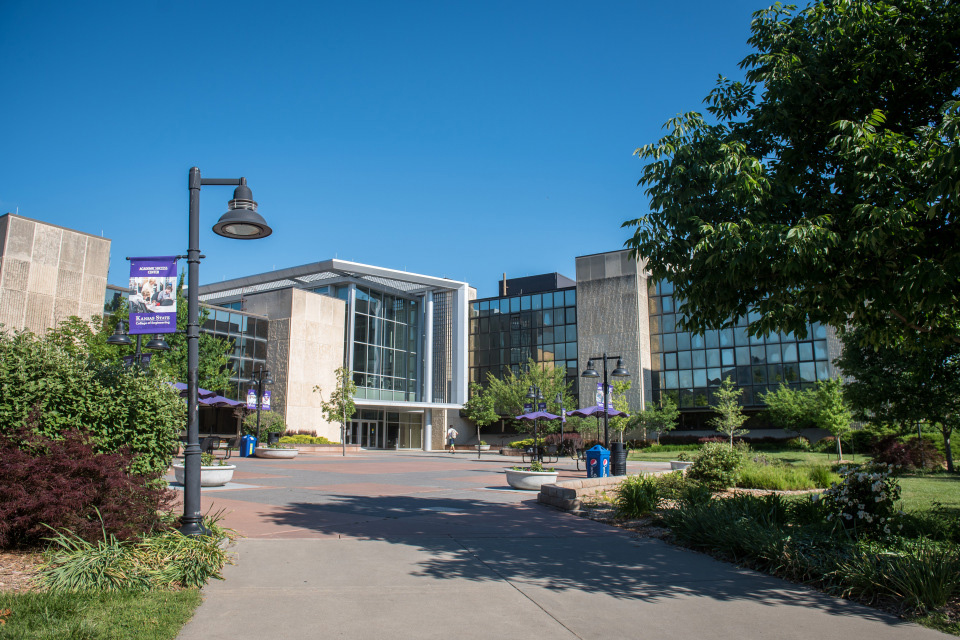 An interior shot shows a staircase and glass-paneled hallways in a college's engineering complex.