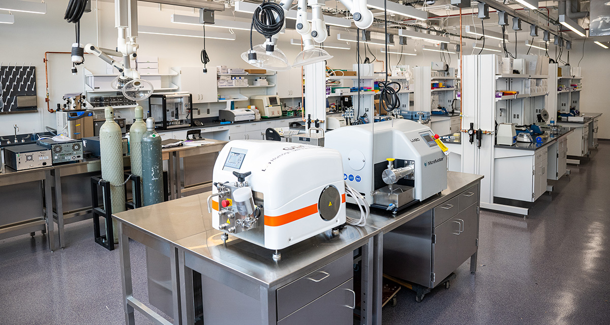 Several pieces of equipment and machinery sit on tables and benches inside a research laboratory.