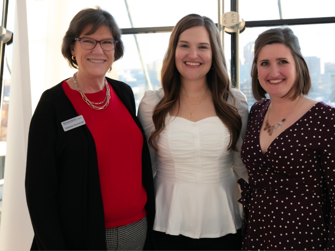 Lauren Racki, right, smiles with two other women at a K-State Olathe event.