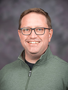 Nathan Albin smiles for a portrait. 