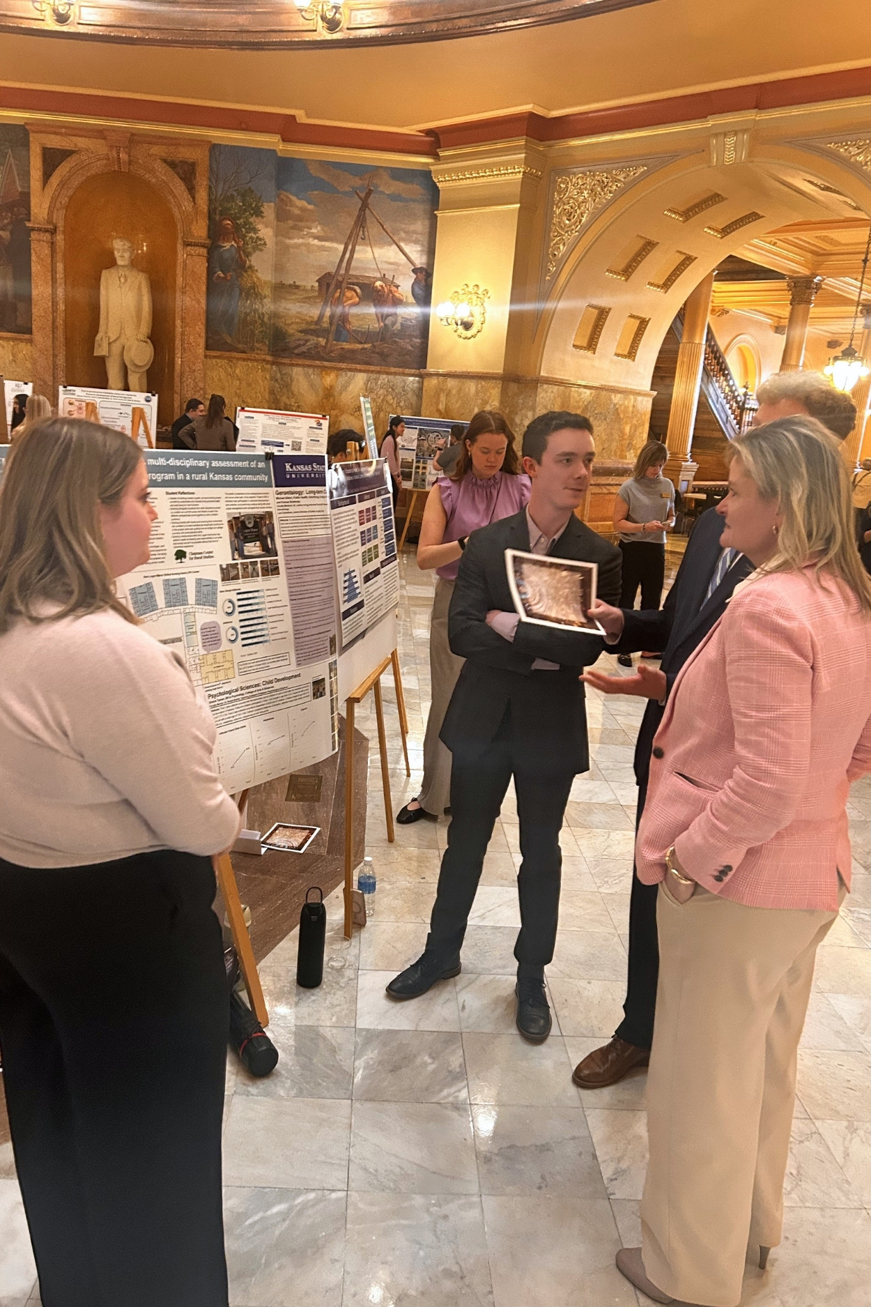 Students present their research findings in the Kansas rotunda.