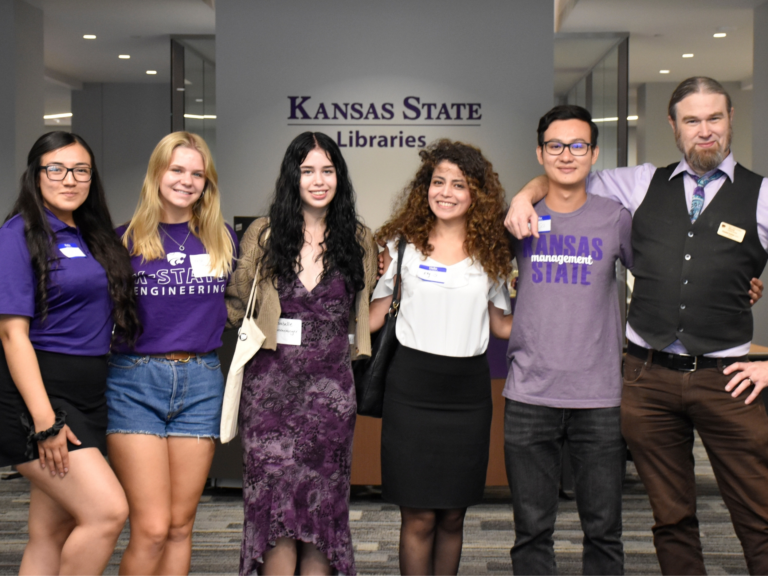 Ireton and students pose for a photo on the first floor of Hale Library