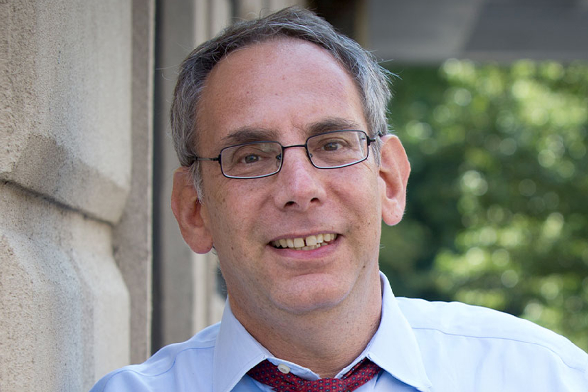 Dave Isay smiles for an outdoor portrait.