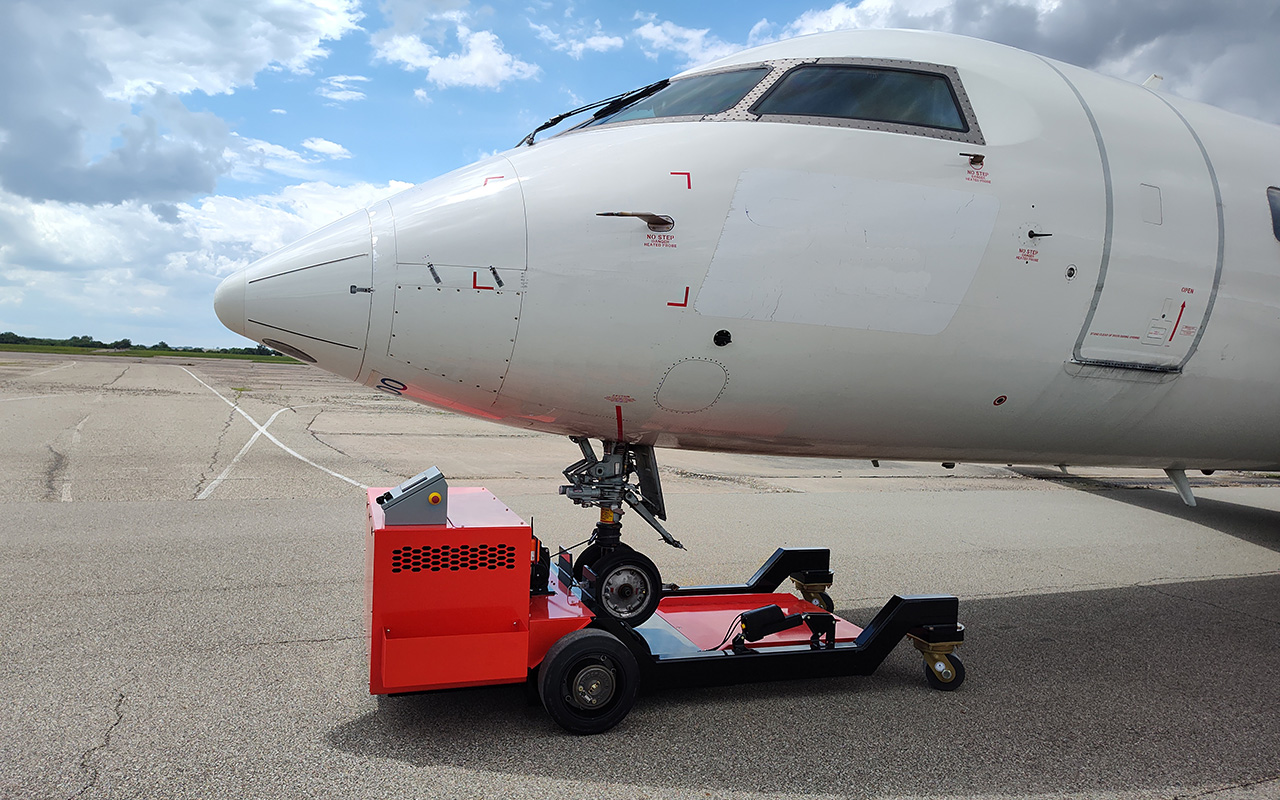 A plane on a tarmac on a sunny day.