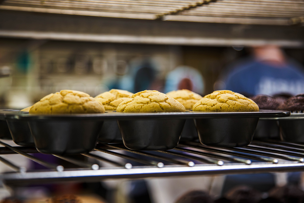 Muffins cool after baking on a wire rack.