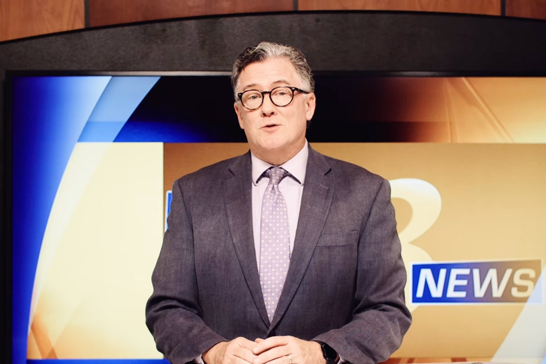 Andrew Smith sitting at the Channel 8 News desk
