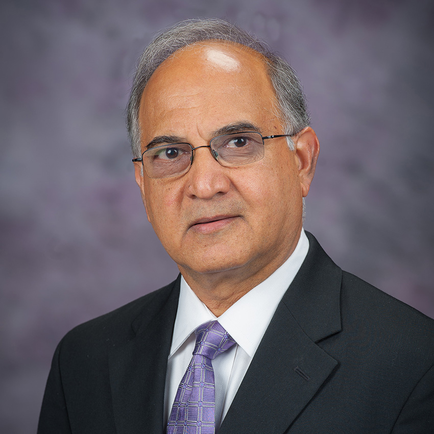 Anil Pahwa smiles for a professional portrait. 