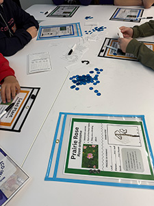 A scientific board game laid out on a table. 